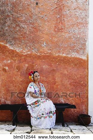 Woman sitting on bench in traditional Mexican clothing View Large Photo Image Picture - Woman sitting on bench in traditional Mexican clothing. Fotosearch