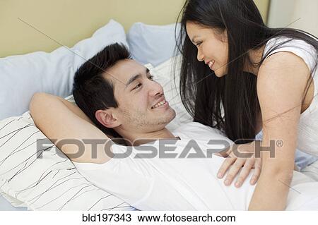 Woman smiling at husband in bed View Large Photo Image Stock Image - Woman smiling at husband in bed. Fotosearch