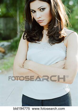 Woman standing with arms crossed View Large Photo Image Stock Photography - Woman standing with arms crossed. Fotosearch