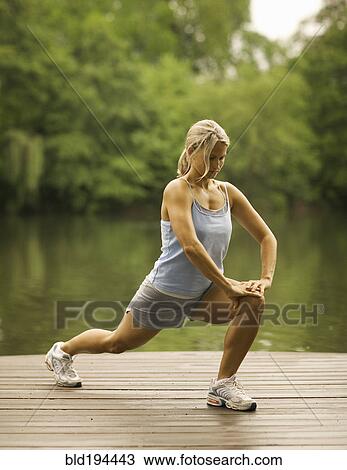 Woman stretching on pier View Large Photo Image Stock Image - Woman stretching on pier. Fotosearch