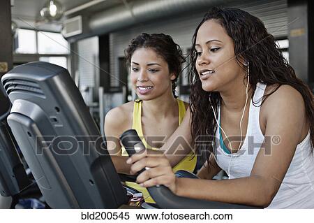 Stock Photography - Women exercising in health club. Fotosearch