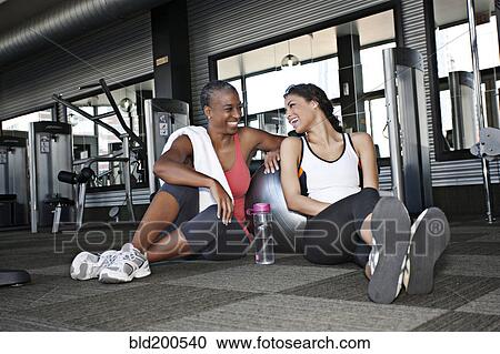 Women sitting together and talking in health club View Large Photo Image Stock Image - Women sitting together and talking in health club. Fotosearch