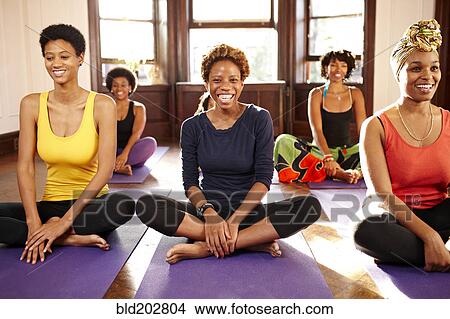 Picture - Women smiling in yoga class. Fotosearch