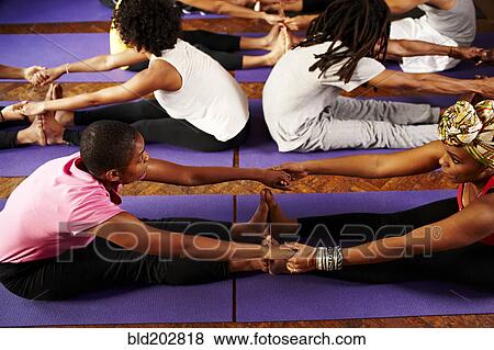 Women stretching together in yoga class View Large Photo Image Stock Photo - Women stretching together in yoga class. Fotosearch