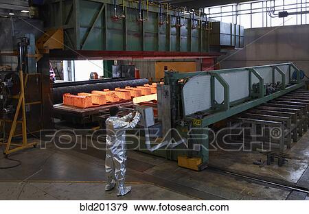 Stock Photo - Worker near factory oven. Fotosearch
