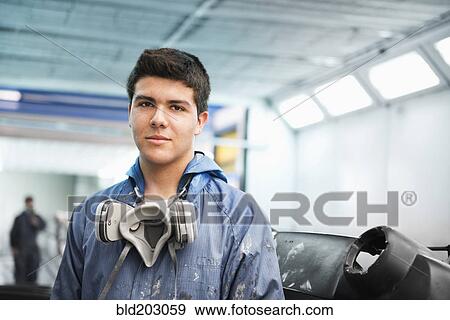 Worker smiling in manufacturing plant View Large Photo Image Stock Photo - Worker smiling in manufacturing plant. Fotosearch