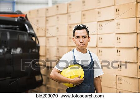 Worker standing in manufacturing plant View Large Photo Image Stock Image - Worker standing in manufacturing plant. Fotosearch