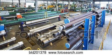 Stock Photo - Workers and piping in factory. Fotosearch