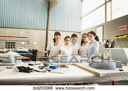 Workers smiling in manufacturing plant View Large Photo Image Stock Photograph - Workers smiling in manufacturing plant. Fotosearch
