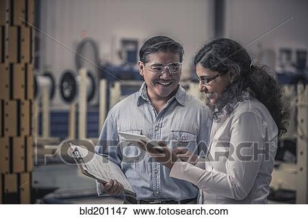 Stock Photo - Workers talking in factory. Fotosearch