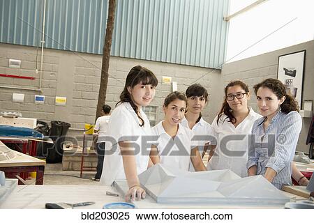 Stock Photography - Workers talking in manufacturing plant. Fotosearch