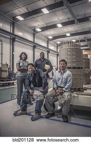 Stock Photo - Workers together in factory. Fotosearch