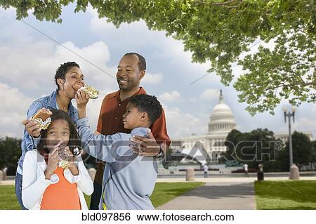 African American family eating hot dogs on vacation View Large Photo Image Stock Photograph - African American family eating hot dogs on vacation. Fotosearch