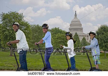 Stock Photo - African American family sightseeing segways on vacation. Fotosearch