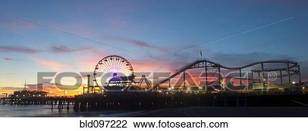 Stock Image - Amusement park on waterfront at night. Fotosearch