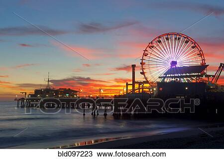 Stock Image - Amusement park on waterfront at night. Fotosearch
