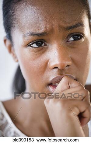 Anxious Black woman frowning View Large Photo Image Stock Image - Anxious Black woman frowning. Fotosearch