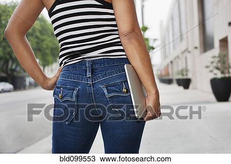 Asian woman carrying digital tablet on urban street View Large Photo Image Stock Image - Asian woman carrying digital tablet on urban street. Fotosearch