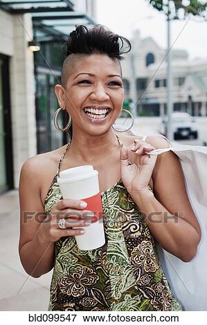 Stock Photo - Asian woman shopping and drinking coffee. Fotosearch