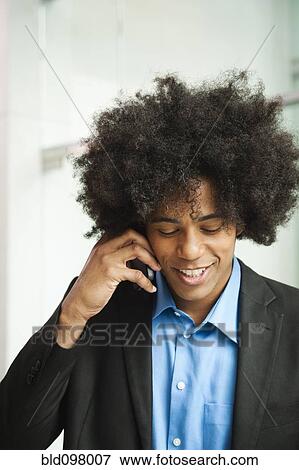 Stock Photo - Black businessman talking on cell phone. Fotosearch