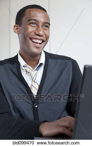 Black businessman typing on laptop View Large Photo Image Stock Image - Black businessman typing on laptop. Fotosearch