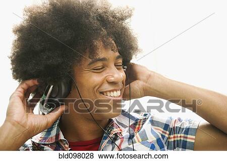 Black man listening to music with headphones View Large Photo Image Stock Photo - Black man listening to music with headphones. Fotosearch