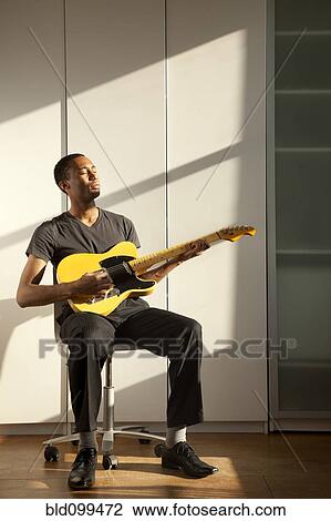 Black man playing guitar View Large Photo Image Stock Image - Black man playing guitar. Fotosearch