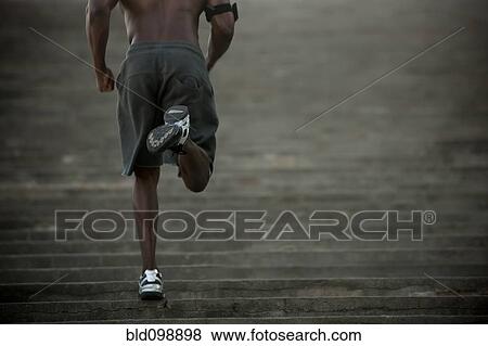 Stock Photo - Black man running up stairs. Fotosearch