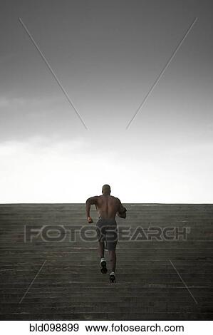 Stock Photo - Black man running up stairs. Fotosearch