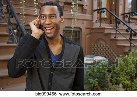 Stock Photograph - Black man talking on cell phone. Fotosearch