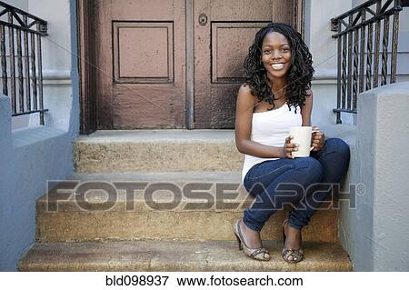 Black woman drinking coffee on front stoop View Large Photo Image Stock Photo - Black woman drinking coffee on front stoop. Fotosearch