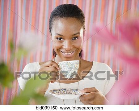 Stock Image - Black woman drinking tea. Fotosearch