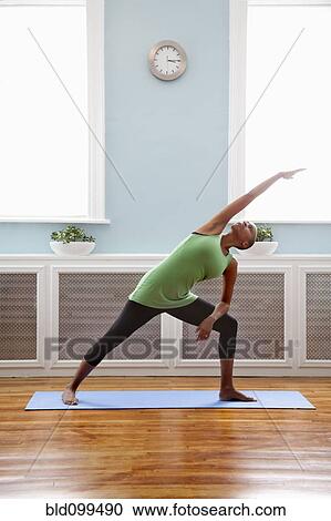 Stock Image - Black woman practicing yoga. Fotosearch