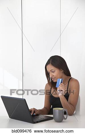 Black woman shopping online with credit card View Large Photo Image Stock Photograph - Black woman shopping online with credit card. Fotosearch