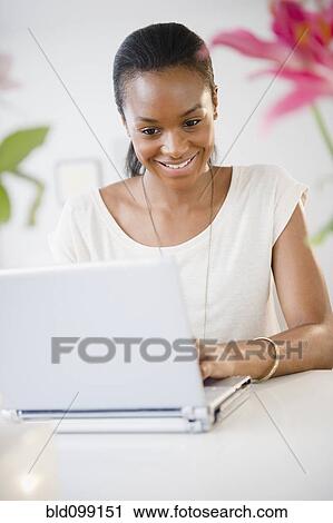 Black woman typing on laptop View Large Photo Image Stock Image - Black woman typing on laptop. Fotosearch