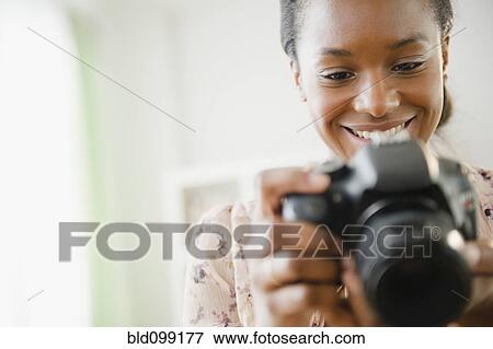 Black woman using digital SLR camera View Large Photo Image Stock Photo - Black woman using digital SLR camera. Fotosearch