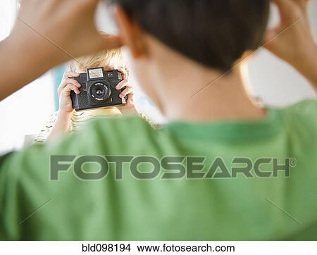 Picture - Boy taking picture of friend. Fotosearch