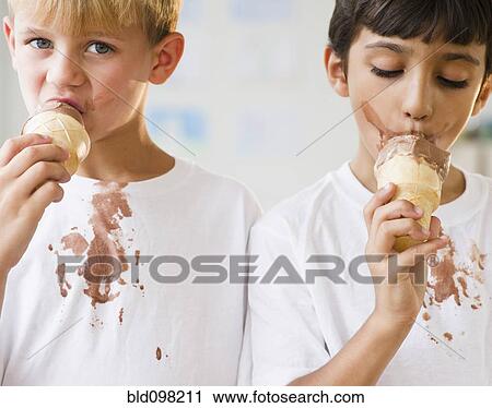 Stock Image - Boys eating dripping ice cream cones. Fotosearch