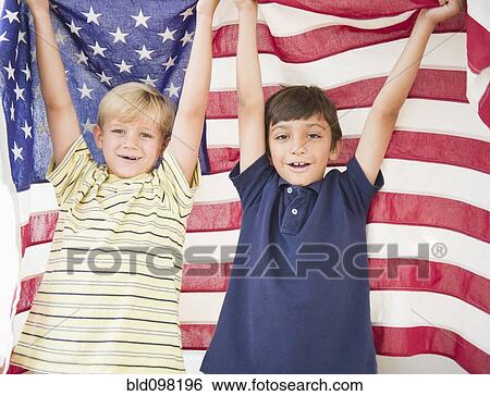 Stock Photograph - Boys holding American flag together. Fotosearch