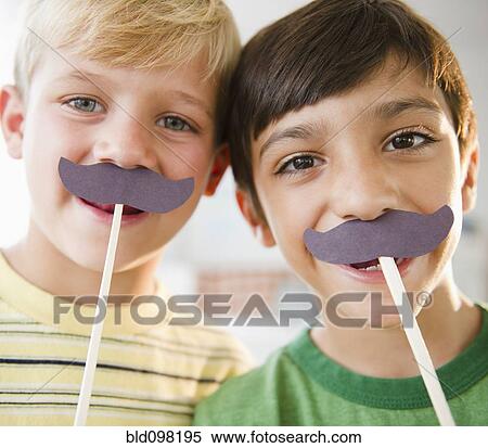 Stock Photography - Boys playing with costume mustaches. Fotosearch