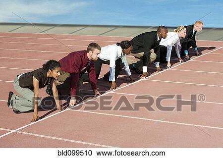 Business people crouching at starting line on track View Large Photo Image Stock Image - Business people crouching at starting line on track. Fotosearch