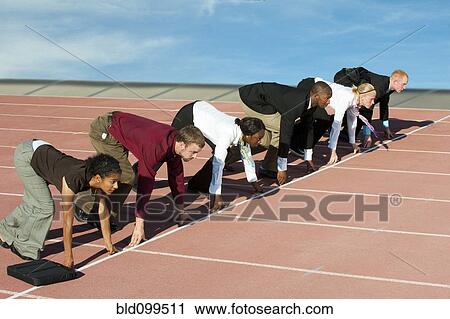 Stock Image - Business people crouching at starting line on track. Fotosearch