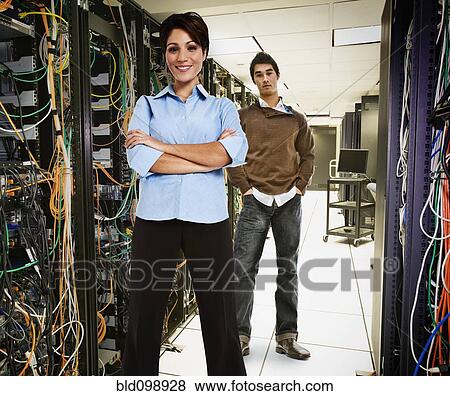 Stock Photo - Business people standing together in server room. Fotosearch