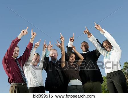 Business people standing together with arms raised View Large Photo Image Stock Photography - Business people standing together with arms raised. Fotosearch