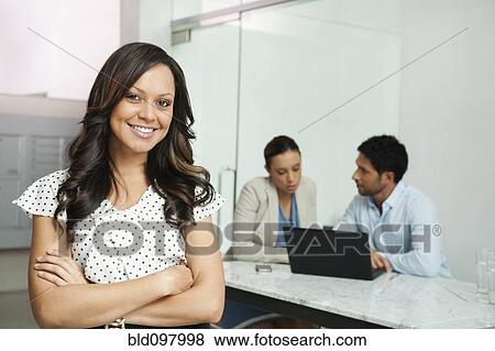 Stock Photo - Business people working in office. Fotosearch