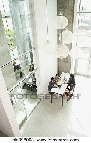 Stock Photo - Business people working together in office. Fotosearch