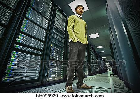 Stock Photo - Businessman standing in server room. Fotosearch