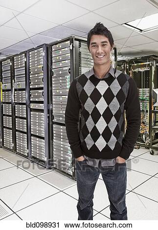 Stock Image - Businessman standing together in server room. Fotosearch