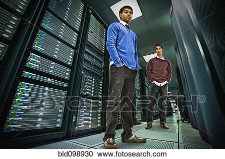 Businessmen standing together in server room View Large Photo Image Stock Image - Businessmen standing together in server room. Fotosearch