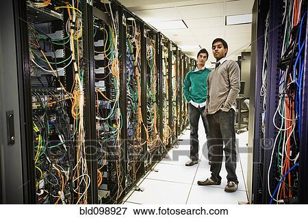 Businessmen standing together in server room View Large Photo Image Stock Photo - Businessmen standing together in server room. Fotosearch